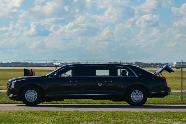 The US President's official vehicle known as "The Beast", drives with its trunk open, as US President Donald Trump's motorcade travels to Palm Beach International Airport in West Palm Beach, Florida, on November 9, 2025. Trump is returning to Washington DC after spending part of the weekend at his Florida residence of Mar-a-Lago. (Photo by Jim WATSON / AFP)