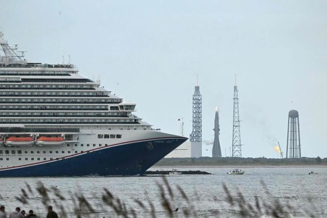 A cruise ship sails by Blue Origin's New Glenn rocket in Space Launch Complex 36 at the Space Force Station in Cape Canaveral, Florida on November 9, 2025. New Glenn, the towering rocket built by Jeff Bezos's space company Blue Origin, is set to take off on its second mission Sunday as competition intensifies with Elon Musk's SpaceX. (Photo by CHANDAN KHANNA / AFP)