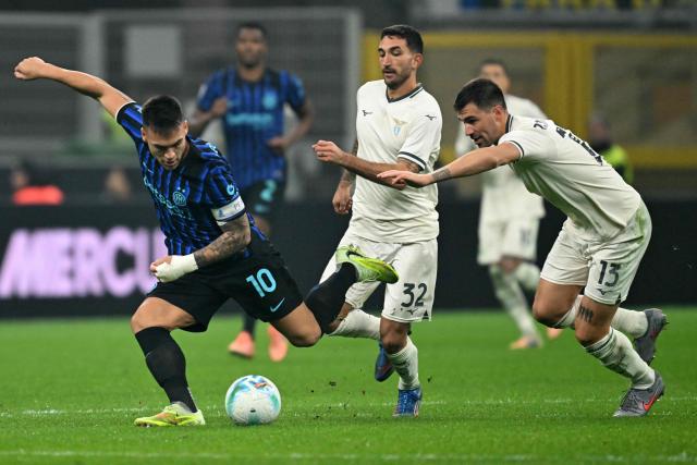 Inter Milan's Argentinian forward #10 Lautaro Martinez fights for the ball with Lazio's Italian defender #13 Alessio Romagnoli during the Italian Serie A football match between Inter Milan and Lazio at San Siro stadium in Milan, on November 9, 2025. (Photo by Stefano RELLANDINI / AFP)