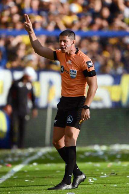 Referee Nicolas Ramirez gestures during the Argentine Professional Football League 2025 Clausura Tournament match between Boca Juniors and River Plate at the La Bombonera Stadium in Buenos Aires on November 9, 2025. (Photo by Luis ROBAYO / AFP)