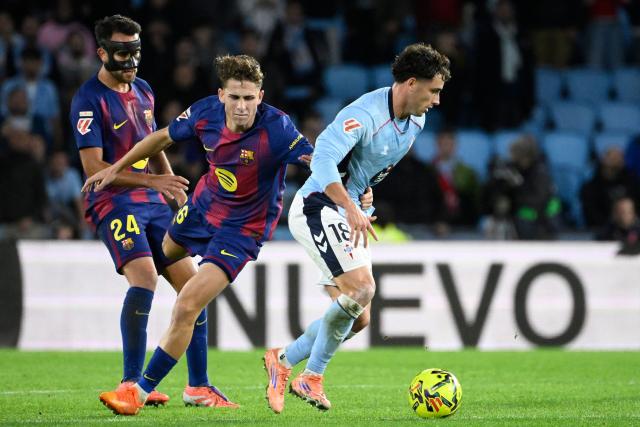 Barcelona's Spanish defender #24 Eric Garcia, Barcelona's Spanish midfielder #16 Fermin Lopez and Celta Vigo's Spanish forward #18 Pablo Duran vie for the ball during the Spanish league football match between RC Celta de Vigo and FC Barcelona at Balaidos Stadium in Vigo on November 9, 2025. (Photo by Miguel RIOPA / AFP)