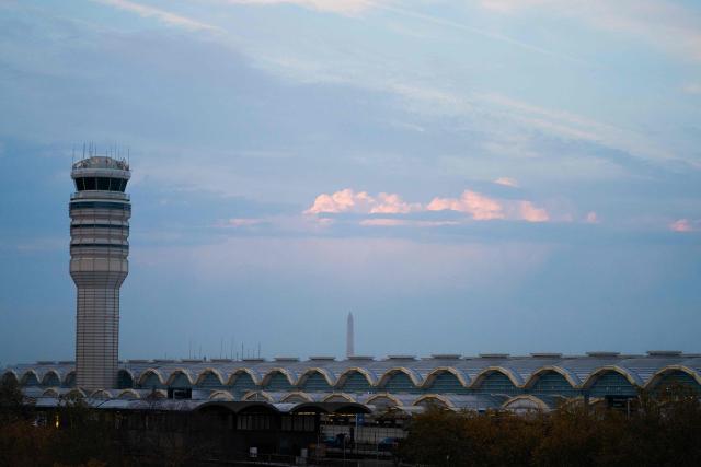 The air traffic control tower at Reagan National Airport in Arlington, Virginia, on day 40 of the government shutdown, on November 9, 2025. Hundreds of flights were canceled across the United States on Friday after the Trump administration ordered reductions to ease strain on air traffic controllers who are working without pay amid congressional paralysis on funding the US budget. Forty airports were due to slow down, including the giant hubs in Atlanta, Newark, Denver, Chicago, Houston and Los Angeles. (Photo by Allison ROBBERT / AFP)