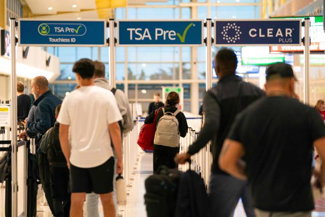 People at the Reagan National Airport security line in Arlington, Virginia, on day 40 of the government shutdown, on November 9, 2025. Hundreds of flights were canceled across the United States on Friday after the Trump administration ordered reductions to ease strain on air traffic controllers who are working without pay amid congressional paralysis on funding the US budget. Forty airports were due to slow down, including the giant hubs in Atlanta, Newark, Denver, Chicago, Houston and Los Angeles. (Photo by Allison ROBBERT / AFP)