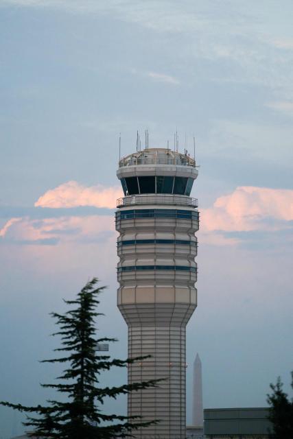 The air traffic control tower at Reagan National Airport in Arlington, Virginia, on day 40 of the government shutdown, on November 9, 2025. Hundreds of flights were canceled across the United States on Friday after the Trump administration ordered reductions to ease strain on air traffic controllers who are working without pay amid congressional paralysis on funding the US budget. Forty airports were due to slow down, including the giant hubs in Atlanta, Newark, Denver, Chicago, Houston and Los Angeles. (Photo by Allison ROBBERT / AFP)