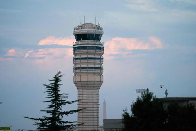 The air traffic control tower at Reagan National Airport in Arlington, Virginia, on day 40 of the government shutdown, on November 9, 2025. Hundreds of flights were canceled across the United States on Friday after the Trump administration ordered reductions to ease strain on air traffic controllers who are working without pay amid congressional paralysis on funding the US budget. Forty airports were due to slow down, including the giant hubs in Atlanta, Newark, Denver, Chicago, Houston and Los Angeles. (Photo by Allison ROBBERT / AFP)