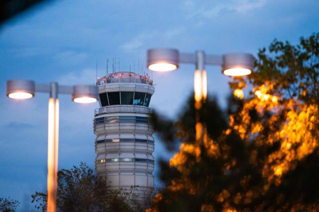 The air traffic control tower at Reagan National Airport in Arlington, Virginia, on day 40 of the government shutdown, on November 9, 2025. Hundreds of flights were canceled across the United States on Friday after the Trump administration ordered reductions to ease strain on air traffic controllers who are working without pay amid congressional paralysis on funding the US budget. Forty airports were due to slow down, including the giant hubs in Atlanta, Newark, Denver, Chicago, Houston and Los Angeles. (Photo by Allison ROBBERT / AFP)