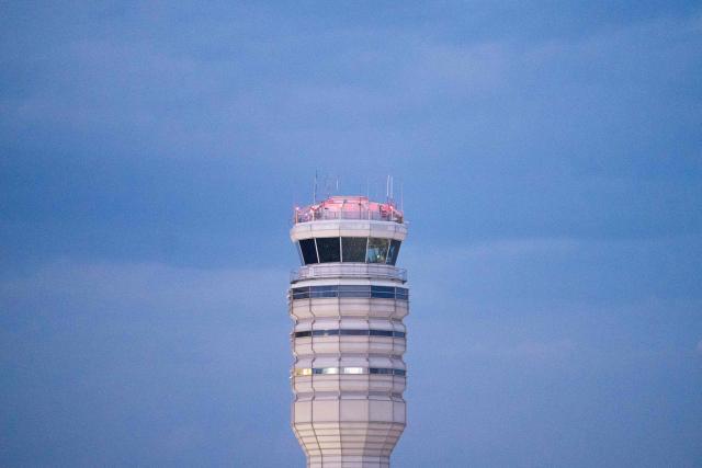 The air traffic control tower at Reagan National Airport in Arlington, Virginia, on day 40 of the government shutdown, on November 9, 2025. Hundreds of flights were canceled across the United States on Friday after the Trump administration ordered reductions to ease strain on air traffic controllers who are working without pay amid congressional paralysis on funding the US budget. Forty airports were due to slow down, including the giant hubs in Atlanta, Newark, Denver, Chicago, Houston and Los Angeles. (Photo by Allison ROBBERT / AFP)