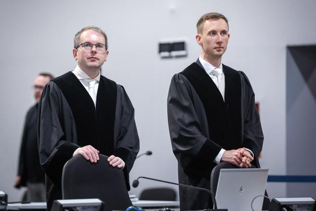 Chief Public Prosecutor Matthias Böttcher (R) and Public Prosecutor Marco Reinl wait at the temporary courtroom in Magdeburg, eastern Germany on November 10, 2025, after a break during the trial over the deadly Christmas market attack in December 2024. The Saudi medical doctor is accused of driving an SUV through a Christmas market in a rampage in the eastern German city of Magdeburg on December 20, 2024. The attack killed a nine-year-old boy and five women aged between 45 and 75. He will face six counts of murder and 338 counts of attempted murder in a trial expected to last until at least March. Prosecutors charge that Abdulmohsen - a harsh critic of Islam and an adherent of far-right views and radical conspiracy theories - was motivated by "dissatisfaction and frustration". (Photo by RONNY HARTMANN / AFP)
