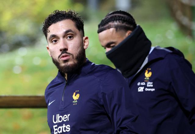 France's forward Rayan Cherki (L) and France's defender #17 Malo Gusto arrive for a training session as part of the preparations for the upcoming FIFA World Cup 2026 Group D European qualification football matches, at the team's training grounds in Clairefontaine-en-Yvelines, southwest of Paris, on November 10, 2025. France will face Ukraine on November 13 and Azerbaidjan on November 17, 2025. (Photo by FRANCK FIFE / AFP)