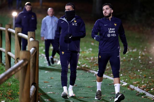 France's forward Rayan Cherki (R) and France's defender #17 Malo Gusto arrive for a training session as part of the preparations for the upcoming FIFA World Cup 2026 Group D European qualification football matches, at the team's training grounds in Clairefontaine-en-Yvelines, southwest of Paris, on November 10, 2025. France will face Ukraine on November 13 and Azerbaidjan on November 17, 2025. (Photo by FRANCK FIFE / AFP)