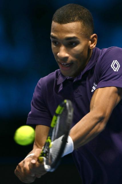 Canada's Felix Auger-Aliassime hits the ball during his match against Italy's Jannik Sinner at the ATP Finals tennis tournament in Turin on November 10, 2025. (Photo by Marco BERTORELLO / AFP)