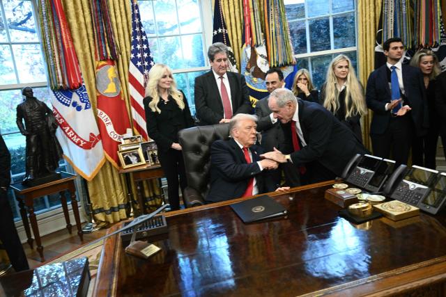 US President Donald Trump shakes hands with US Senator James Risch, Republican from Idaho during a swearing-in ceremony for the newly appointed Ambassador to India Sergio Gor in the Oval Office of the White on November 10, 2025 in Washington, DC. (Photo by Brendan SMIALOWSKI / AFP)