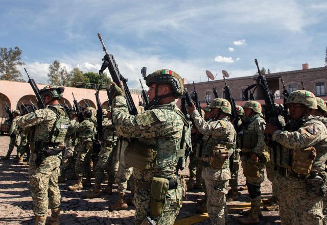 Military personnel stand in formation after their arrival to the Morelos Barracks of the 21st Military Zone in Morelia, Michoacan state, Mexico on November 10, 2025. Mexico's President Claudia Sheinbaum government announced on November 9, 2025, the reinforcement of military presence and official bodies in the state of Michoacan (west) after the murder of a mayor that has outraged the country. (Photo by ENRIQUE CASTRO / AFP)
