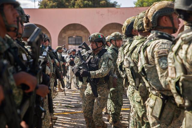 Military personnel arrive at the Morelos Barracks of the 21st Military Zone in Morelia, Michoacan state, Mexico on November 10, 2025. Mexico's President Claudia Sheinbaum government announced on November 9, 2025, the reinforcement of military presence and official bodies in the state of Michoacan (west) after the murder of a mayor that has outraged the country. (Photo by Carl DE SOUZA and ENRIQUE CASTRO / AFP)