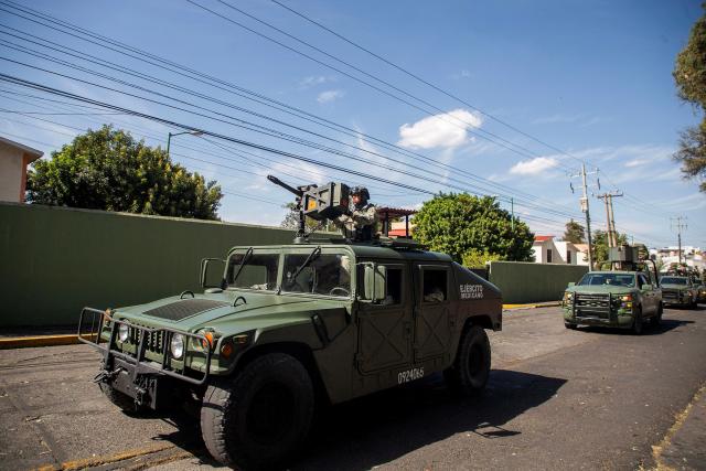 Military personnel arrive at the Morelos Barracks of the 21st Military Zone in Morelia, Michoacan state, Mexico on November 10, 2025. Mexico's President Claudia Sheinbaum government announced on November 9, 2025, the reinforcement of military presence and official bodies in the state of Michoacan (west) after the murder of a mayor that has outraged the country. (Photo by Enrique CASTRO / AFP)