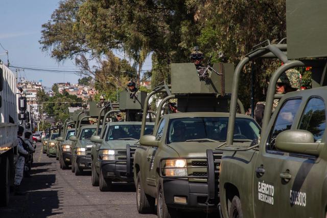 Military personnel arrive at the Morelos Barracks of the 21st Military Zone in Morelia, Michoacan state, Mexico on November 10, 2025. Mexico's President Claudia Sheinbaum government announced on November 9, 2025, the reinforcement of military presence and official bodies in the state of Michoacan (west) after the murder of a mayor that has outraged the country. (Photo by Carl DE SOUZA and ENRIQUE CASTRO / AFP)