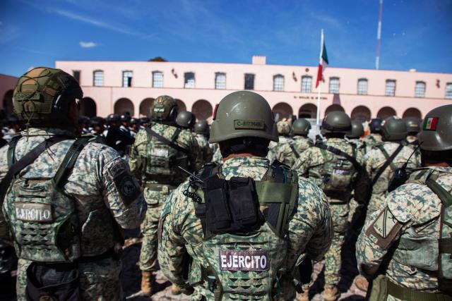 Military personnel arrive at the Morelos Barracks of the 21st Military Zone in Morelia, Michoacan state, Mexico on November 10, 2025. Mexico's President Claudia Sheinbaum government announced on November 9, 2025, the reinforcement of military presence and official bodies in the state of Michoacan (west) after the murder of a mayor that has outraged the country. (Photo by Enrique CASTRO / AFP)