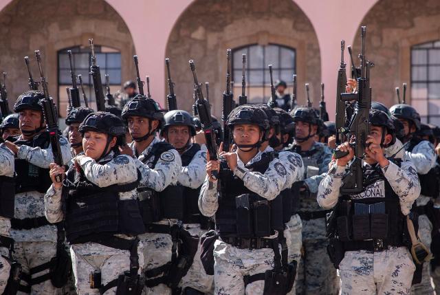 Military personnel stand in formation after their arrive at the Morelos Barracks of the 21st Military Zone in Morelia, Michoacan state, Mexico on November 10, 2025. Mexico's President Claudia Sheinbaum government announced on November 9, 2025, the reinforcement of military presence and official bodies in the state of Michoacan (west) after the murder of a mayor that has outraged the country. (Photo by ENRIQUE CASTRO / AFP)