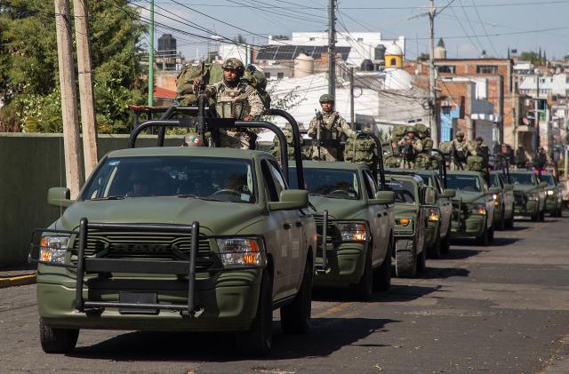 Military personnel arrive at the Morelos Barracks of the 21st Military Zone in Morelia, Michoacan state, Mexico on November 10, 2025. Mexico's President Claudia Sheinbaum government announced on November 9, 2025, the reinforcement of military presence and official bodies in the state of Michoacan (west) after the murder of a mayor that has outraged the country. (Photo by ENRIQUE CASTRO / AFP)