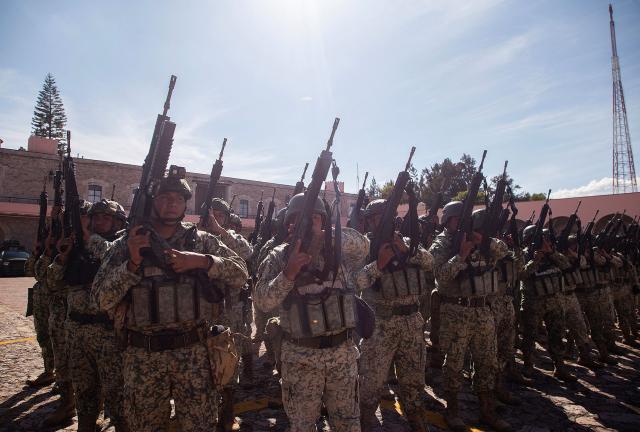 Military personnel stand in formation after their arrive at the Morelos Barracks of the 21st Military Zone in Morelia, Michoacan state, Mexico on November 10, 2025. Mexico's President Claudia Sheinbaum government announced on November 9, 2025, the reinforcement of military presence and official bodies in the state of Michoacan (west) after the murder of a mayor that has outraged the country. (Photo by ENRIQUE CASTRO / AFP)