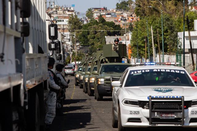 Military personnel arrive at the Morelos Barracks of the 21st Military Zone in Morelia, Michoacan state, Mexico on November 10, 2025. Mexico's President Claudia Sheinbaum government announced on November 9, 2025, the reinforcement of military presence and official bodies in the state of Michoacan (west) after the murder of a mayor that has outraged the country. (Photo by ENRIQUE CASTRO / AFP)