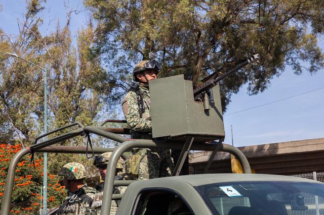 Military personnel arrive at the Morelos Barracks of the 21st Military Zone in Morelia, Michoacan state, Mexico on November 10, 2025. Mexico's President Claudia Sheinbaum government announced on November 9, 2025, the reinforcement of military presence and official bodies in the state of Michoacan (west) after the murder of a mayor that has outraged the country. (Photo by ENRIQUE CASTRO / AFP)