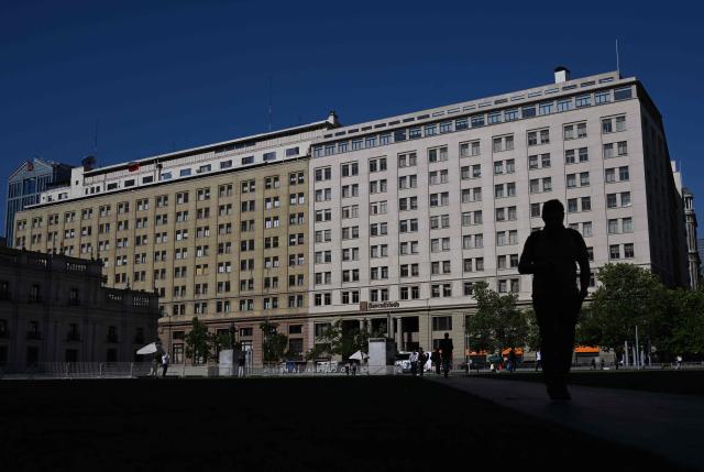 A man walks near La Moneda Presidential palace in Santiago on November 10, 2025. Chile will hold presidential election on November 16. (Photo by Marvin RECINOS / AFP)