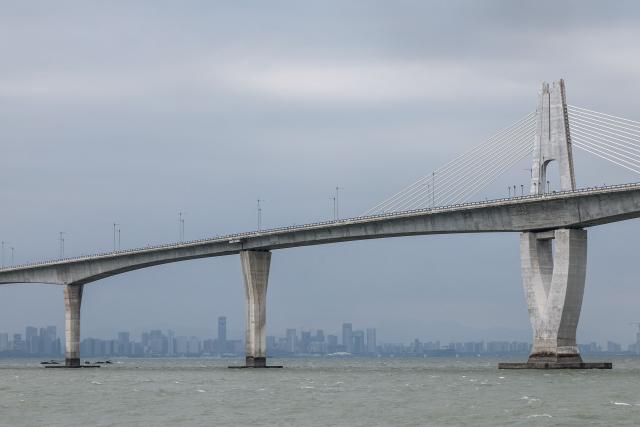 This photo taken on October 28, 2025 shows a general view of Kinmen bridge in Kinmen, before the Chinese city of Xiamen. China claims all of Taiwan as part of its territory and has threatened to use force to bring it under its control. Kinmen, which is two kilometres (1.2 miles) from China and 200 kilometres from Taiwan's main island, has been on the frontline of tensions between Beijing and Taipei for decades. (Photo by I-Hwa Cheng / AFP) / To go with 'TAIWAN-CHINA-DEFENCE-COASTGUARD, FOCUS' by Allison Jackson and Joy Chiang