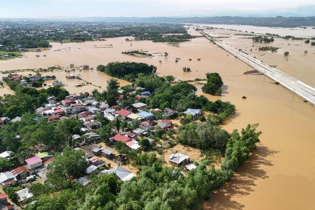 This photo shows an aerial view of a submerged under construction road with flood waters in Tuguegarao City, Cagayan province, north of Manila on November 11, 2025, as flood waters continue to inundate homes due to heavy rains brought about by Super Typhoon Fung-wong. Entire villages lay submerged and scores of towns remained without electricity on November 10 as Typhoon Fung-wong left the Philippines after killing at least five people and displacing more than a million. (Photo by John Dimain / AFP)
