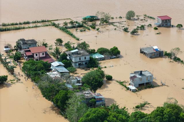 This photo shows an aerial view of submerged houses and farm lands with flood waters in Tuguegarao City, Cagayan province, north of Manila on November 11, 2025, as flood waters continue to inundate homes due to heavy rains brought about by Super Typhoon Fung-wong. Entire villages lay submerged and scores of towns remained without electricity on November 10 as Typhoon Fung-wong left the Philippines after killing at least five people and displacing more than a million. (Photo by John Dimain / AFP)