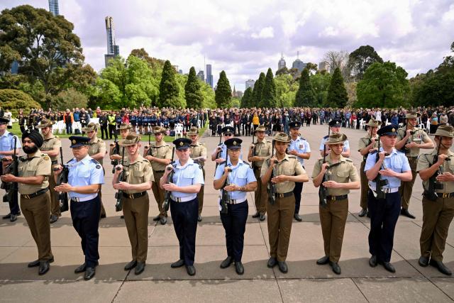 Military personnel stand to attention during a Remembrance Day service at the Shrine of Remembrance in Melbourne on November 11, 2025. Remembrance Day is observed across Commonwealth countries to mark the anniversary of the end of the First World War and to remember servicemen and women who have fallen in the line of duty since WWI. (Photo by William WEST / AFP)