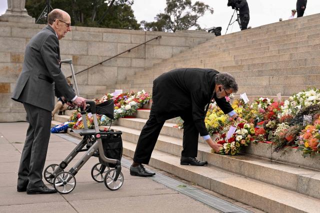 People lay wreaths during a Remembrance Day service at the Shrine of Remembrance in Melbourne on November 11, 2025. Remembrance Day is observed across Commonwealth countries to mark the anniversary of the end of the First World War and to remember servicemen and women who have fallen in the line of duty since WWI. (Photo by William WEST / AFP)