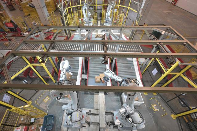 Robots sort packages at JD's warehouse during the double 11 festival or Singles's Day, China's massive annual shopping event in Beijing on November 11, 2025. (Photo by Adek BERRY / AFP)