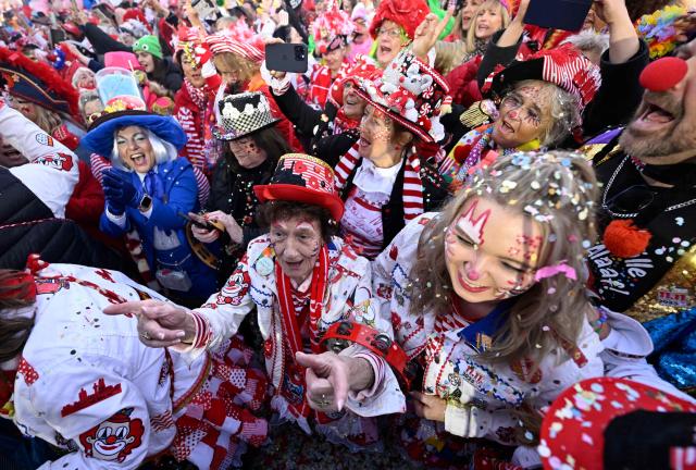 Revellers celebrate the start of the Carnival season in Cologne, western Germany on November 11, 2025. The carnival season usually starts on November 11 at 11:11am and it finishes on Ash Wednesday of the following year with the main festivities happening around Rosenmontag (Rose Monday). (Photo by INA FASSBENDER / AFP)