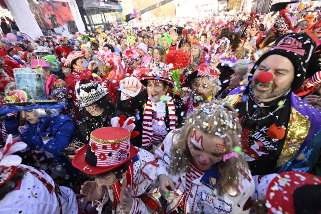 Revellers celebrate the start of the Carnival season in Cologne, western Germany on November 11, 2025. The carnival season usually starts on November 11 at 11:11am and it finishes on Ash Wednesday of the following year with the main festivities happening around Rosenmontag (Rose Monday). (Photo by INA FASSBENDER / AFP)