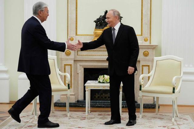 Russian President Vladimir Putin and Kazakh President Kassym-Jomart Tokayev shake hands during their meeting at the Senate Palace of the Kremlin in Moscow on November 11, 2025. (Photo by Alexander Zemlianichenko / POOL / AFP)
