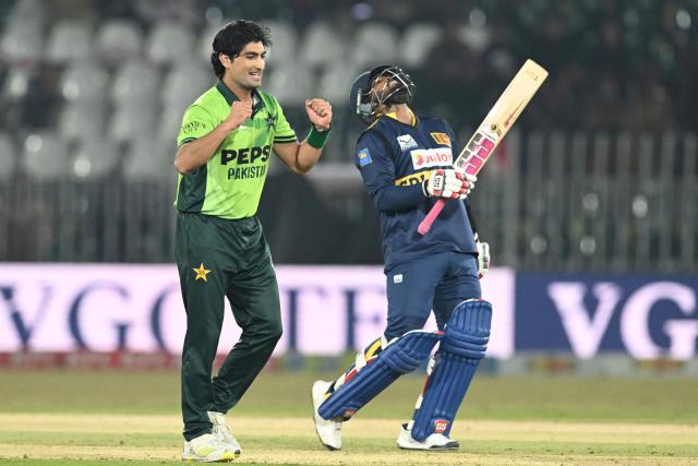 Pakistan's Naseem Shah (L) celebrates after taking the wicket of Sri Lanka's Wanindu Hasaranga (R) during the first one-day international (ODI) cricket match between Pakistan and Sri Lanka at the Rawalpindi Cricket Stadium in Rawalpindi on November 11, 2025. (Photo by Aamir QURESHI / AFP)