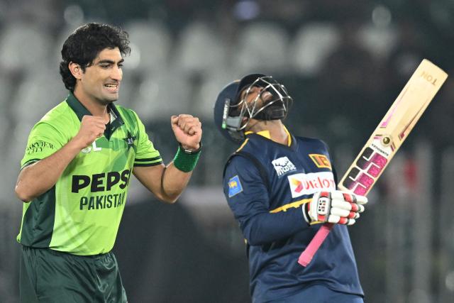 Pakistan's Naseem Shah (L) celebrates after taking the wicket of Sri Lanka's Wanindu Hasaranga (R) during the first one-day international (ODI) cricket match between Pakistan and Sri Lanka at the Rawalpindi Cricket Stadium in Rawalpindi on November 11, 2025. (Photo by Aamir QURESHI / AFP)