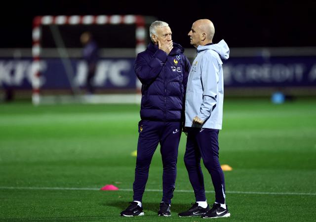 France's head coach Didier Deschamps (L) speaks with France's assistant coach Guy Stephan during a training session at the national team training grounds in Clairefontaine-en-Yvelines, southwest of Paris, on November 11, 2025, as part of preparations for the upcoming FIFA World Cup 2026 Group D European qualification football matches. France will face Ukraine on November 13 and  Azerbaidjan on November 17. (Photo by FRANCK FIFE / AFP)