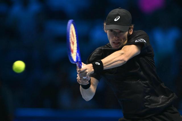 Australia's Alex De Minaur hits the ball during his match against Italy's Lorenzo Musetti at the ATP Finals tennis tournament in Turin on November 11, 2025. (Photo by Marco BERTORELLO / AFP)