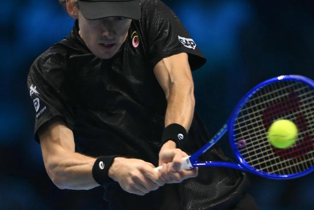 Australia's Alex De Minaur hits the ball during his match against Italy's Lorenzo Musetti at the ATP Finals tennis tournament in Turin on November 11, 2025. (Photo by Marco BERTORELLO / AFP)