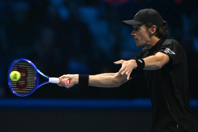 Australia's Alex De Minaur hits the ball during his match against Italy's Lorenzo Musetti at the ATP Finals tennis tournament in Turin on November 11, 2025. (Photo by Marco BERTORELLO / AFP)