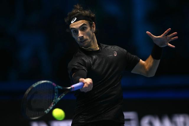 Italy's Lorenzo Musetti hits the ball during his match against Australia's Alex De Minaur at the ATP Finals tennis tournament in Turin on November 11, 2025. (Photo by Marco BERTORELLO / AFP)