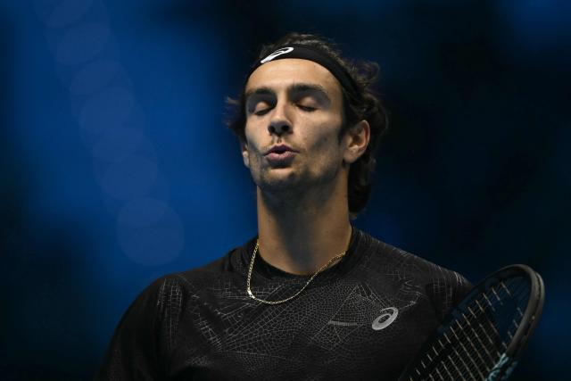 Italy's Lorenzo Musetti reacts during his match against Australia's Alex De Minaur at the ATP Finals tennis tournament in Turin on November 11, 2025. (Photo by Marco BERTORELLO / AFP)