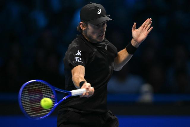 Australia's Alex De Minaur hits the ball during his match against Italy's Lorenzo Musetti at the ATP Finals tennis tournament in Turin on November 11, 2025. (Photo by Marco BERTORELLO / AFP)