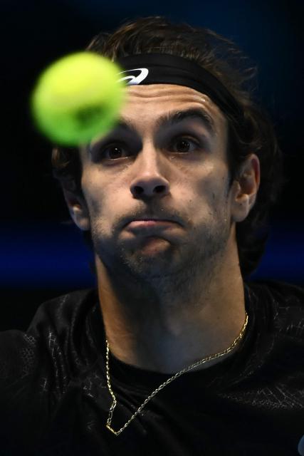 Italy's Lorenzo Musetti eyes the ball during his match against Australia's Alex De Minaur at the ATP Finals tennis tournament in Turin on November 11, 2025. (Photo by Marco BERTORELLO / AFP)