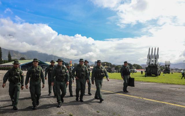 This handout picture released by Venezuela’s Defence Ministry shows Venezuela's Defense Minister Vladimir Padrino Lopez (3nd L) and members of the military high command walking during a training exercise in Caracas on November 11, 2025. A US aircraft carrier strike group arrived in Latin America on Tuesday, escalating a military buildup that Venezuela has warned could trigger a full-blown conflict as it announced its own deployment. (Photo by Handout / Venezuela's Defense Ministry / AFP)