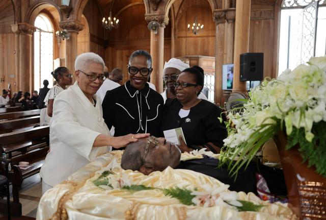 EDITORS NOTE: Graphic content / Relatives attend the funeral of Suriname's three-time former president Ronald Venetiaan at the Petrus and Paulus Cathedral Basilica in Paramaribo on November 11, 2025. Venetiaan, a key architect in the development of the small Dutch-speaking South American country, died Wednesday at the age of 89, his family said. (Photo by Ranu Abhelakh / AFP)