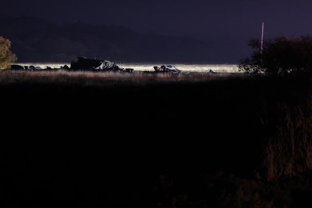 Wreckage is seen at the crash site of the Turkish C-130 military cargo plane in the Sighnaghi area at the Georgia-Azerbaijan border early on November 12, 2025. A Turkish military cargo plane carrying 20 passengers and crew crashed in Georgia on its way home from Azerbaijan, the defence ministry said Tuesday. (Photo by Giorgi ARJEVANIDZE / AFP)
