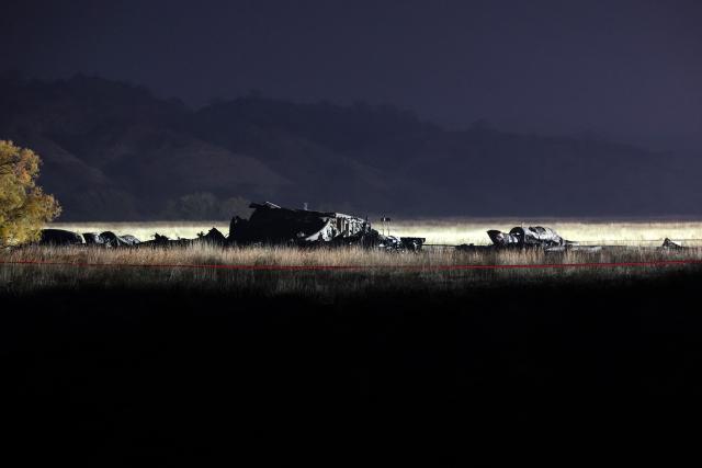 Wreckage is seen at the crash site of the Turkish C-130 military cargo plane in the Sighnaghi area at the Georgia-Azerbaijan border early on November 12, 2025. A Turkish military cargo plane carrying 20 passengers and crew crashed in Georgia on its way home from Azerbaijan, the defence ministry said Tuesday. (Photo by Giorgi ARJEVANIDZE / AFP)